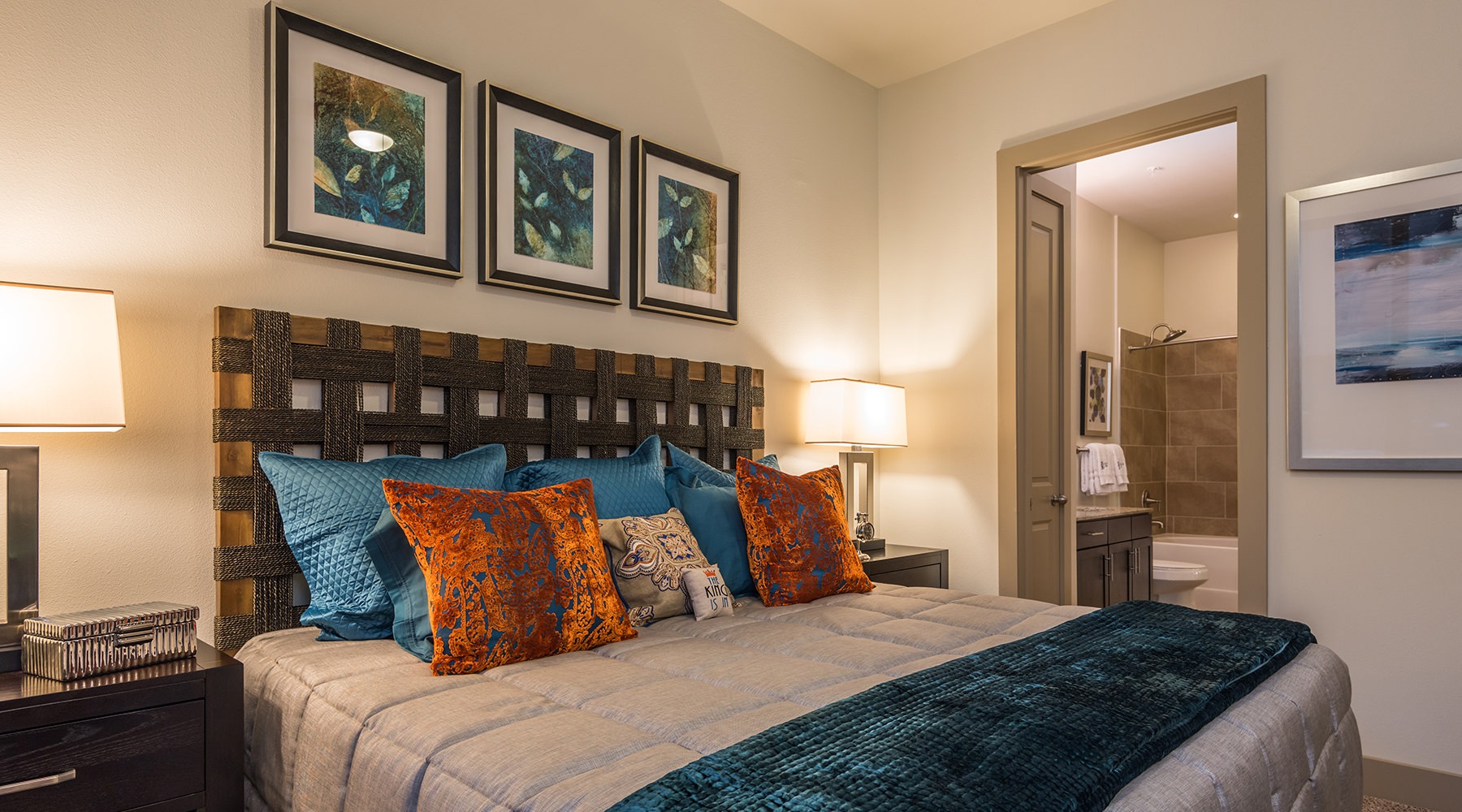 large bed in bedroom with pillows and art on the wall large bed in bedroom with pillows and art on the wall