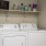 a white washing machine and dryer in a closet