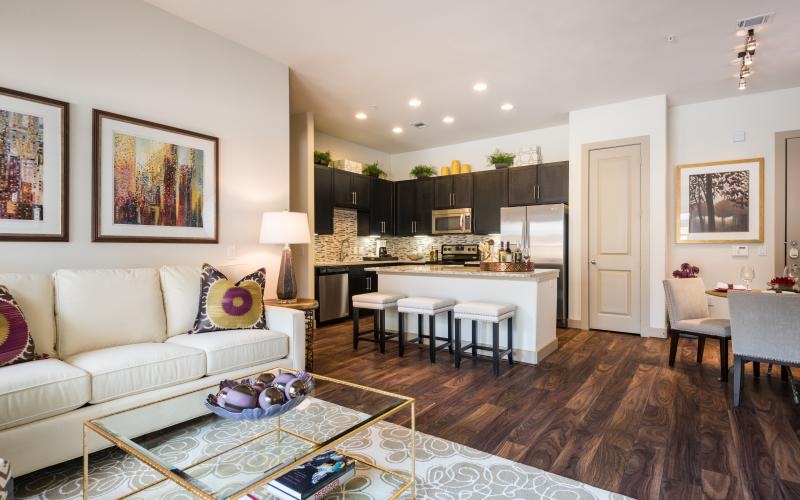 a living room with a large kitchen