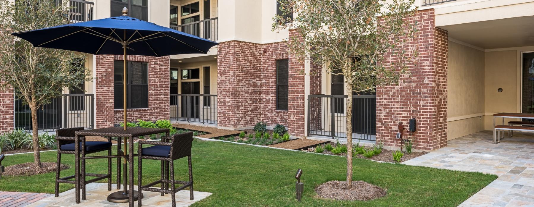 a courtyard with tables and chairs and umbrellas