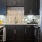 a kitchen with black cabinets